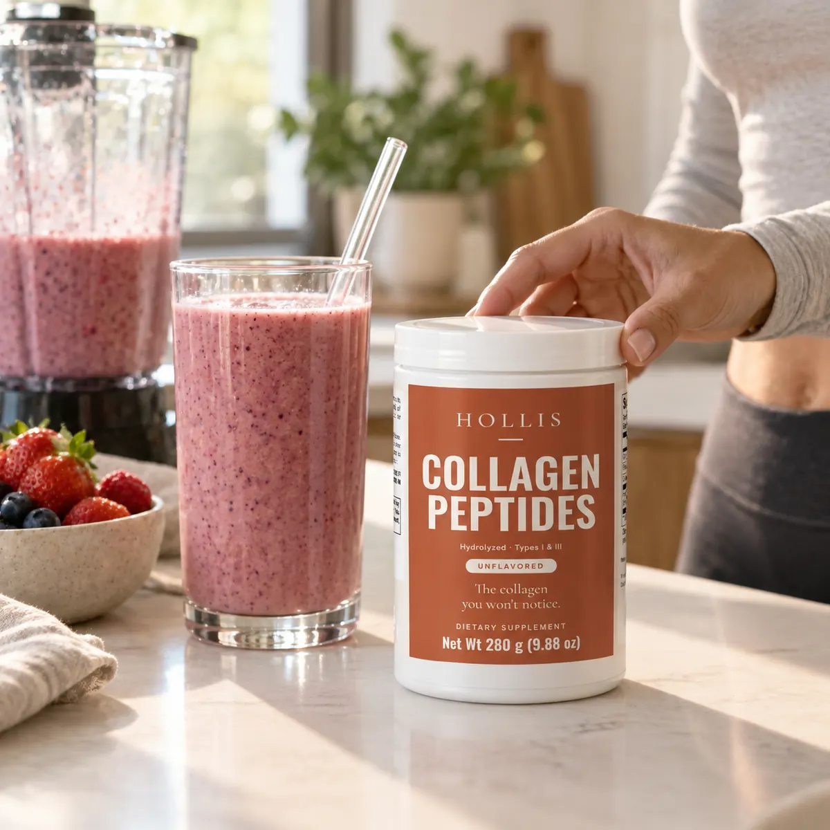 A hand reaching for the Hollis container next to a smoothie